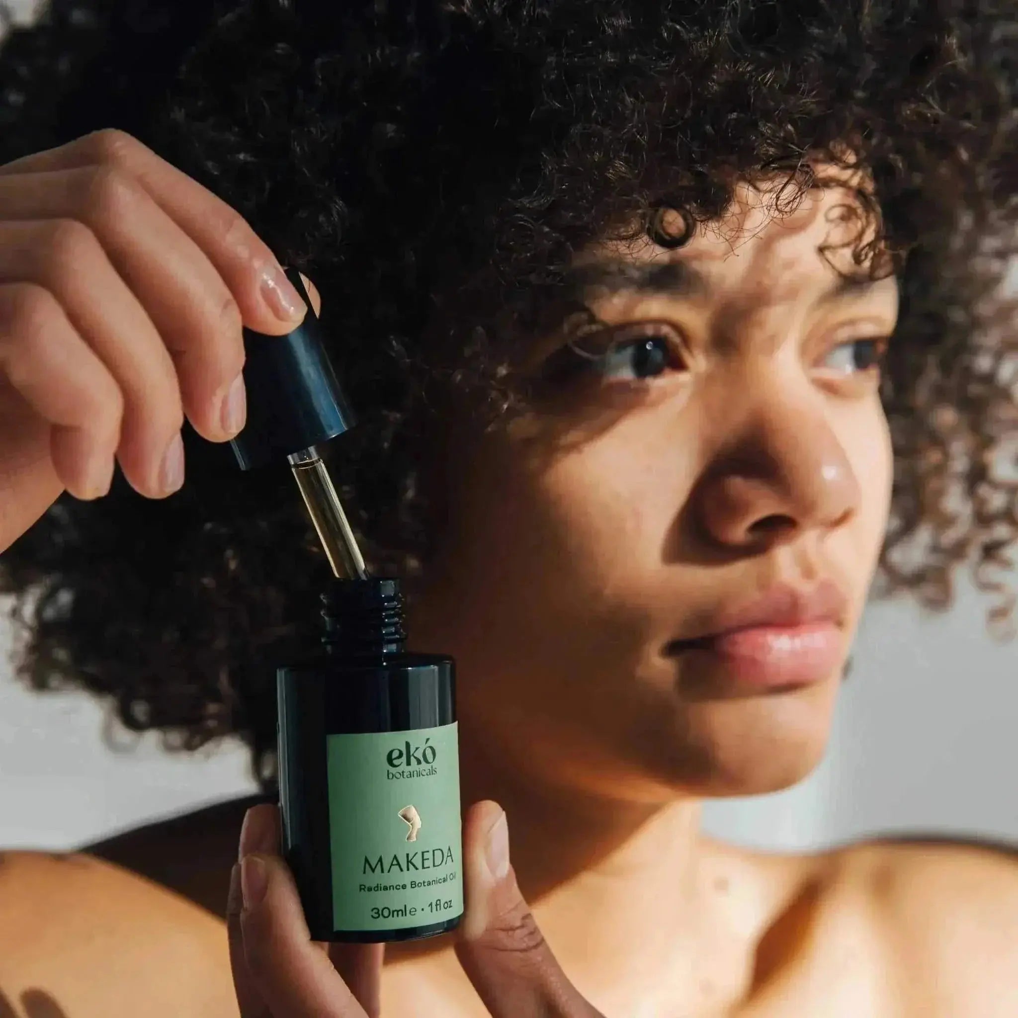 Makeda Radiance Ageless Botanical Oil bottle with natural ingredients